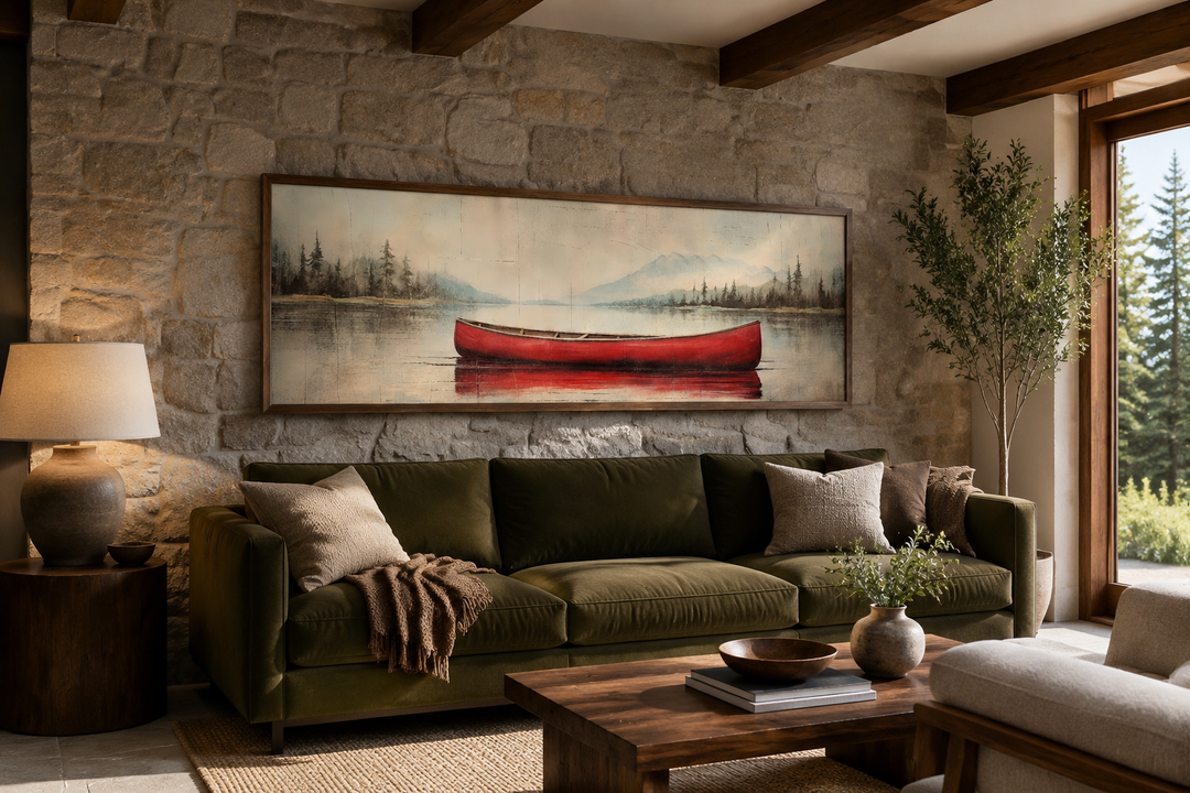 Rustic red canoe on a calm lake, framed horizontal wood-effect canvas wall art above a green sofa.