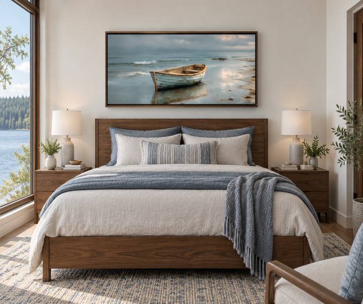 Rustic rowboat on beach coastal framed canvas wall art hanging above a bed in a modern bedroom.