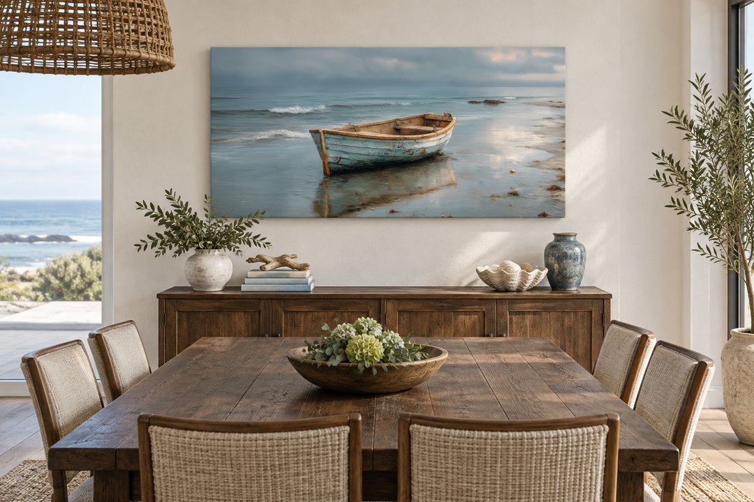 Rustic rowboat on beach coastal framed canvas wall art hanging above a wooden sideboard.