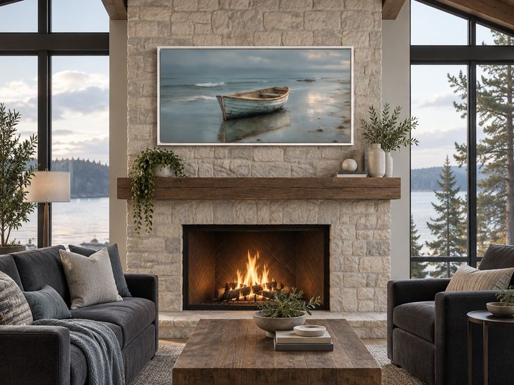 Rustic rowboat on beach coastal framed canvas wall art hanging above a stone fireplace.