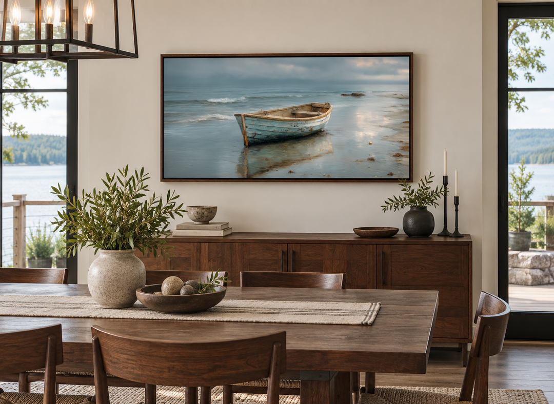 Rustic rowboat on beach coastal framed canvas wall art hanging above a wooden sideboard.