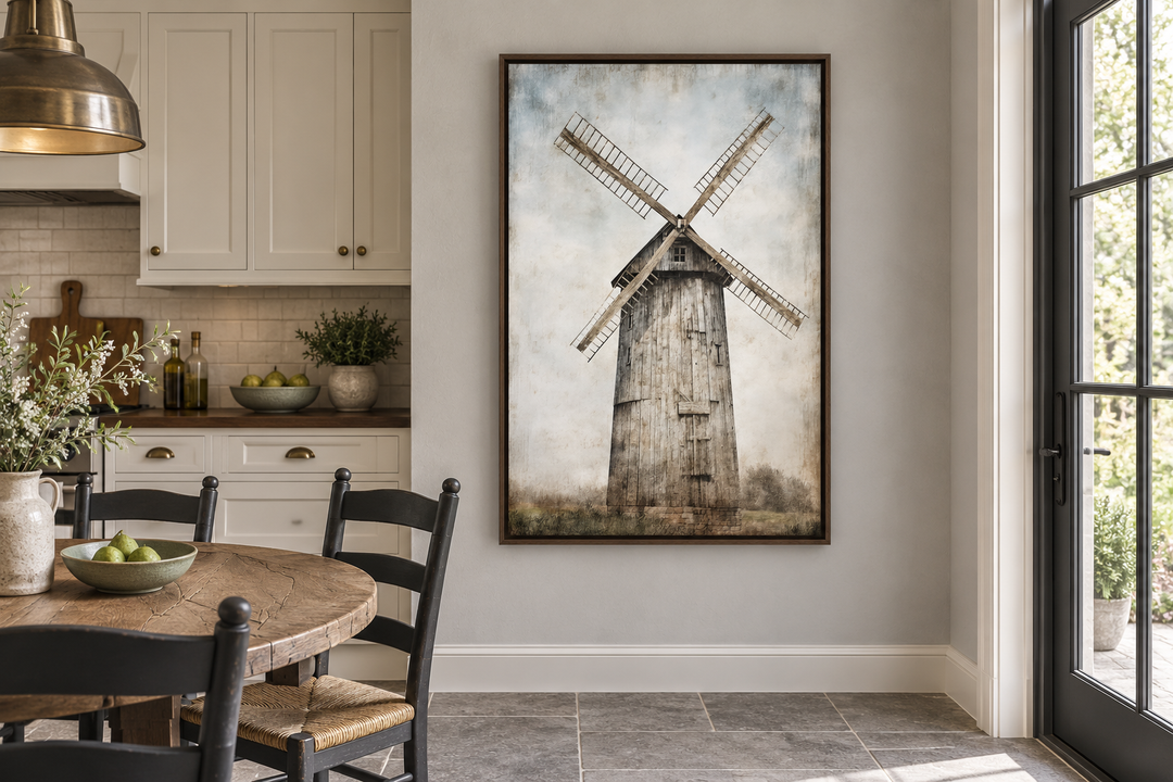 Rustic old windmill painting in a dark wood frame hanging on a wall in a farmhouse kitchen.