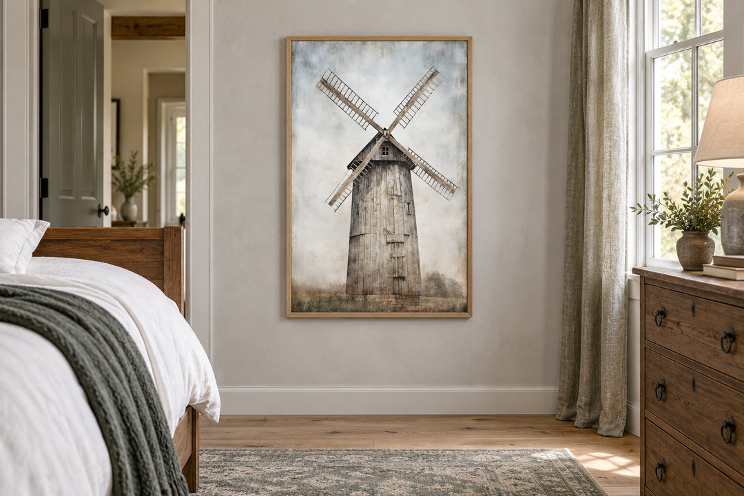 Rustic framed canvas painting of an old windmill in a farmhouse bedroom above a wooden floor.