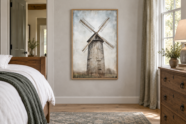 Rustic framed canvas painting of an old windmill in a farmhouse bedroom above a wooden floor.