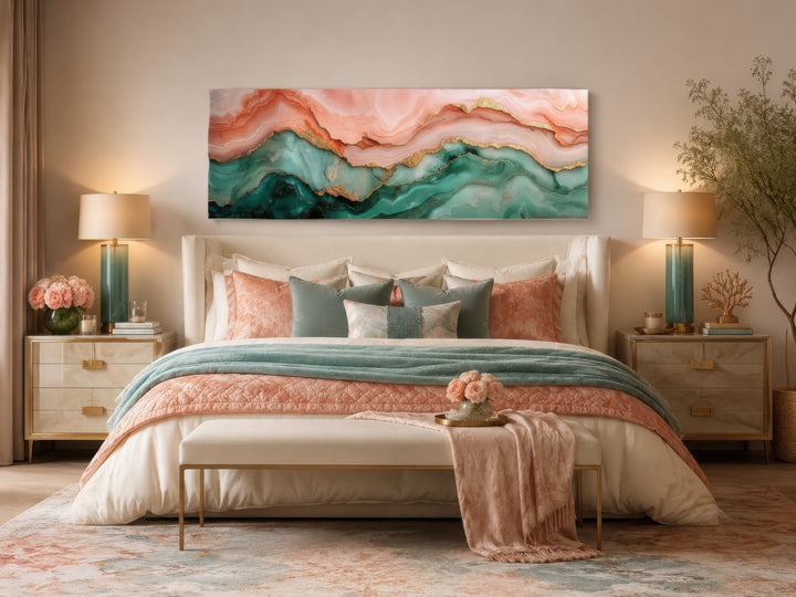 Sage green and blush pink abstract marble horizontal canvas wall art hanging above a bed.