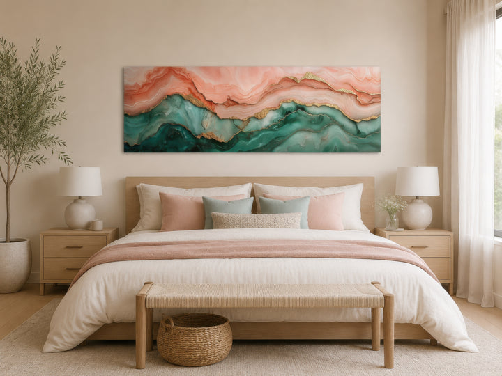 Sage green and blush pink abstract marble horizontal canvas wall art hanging above a bed.
