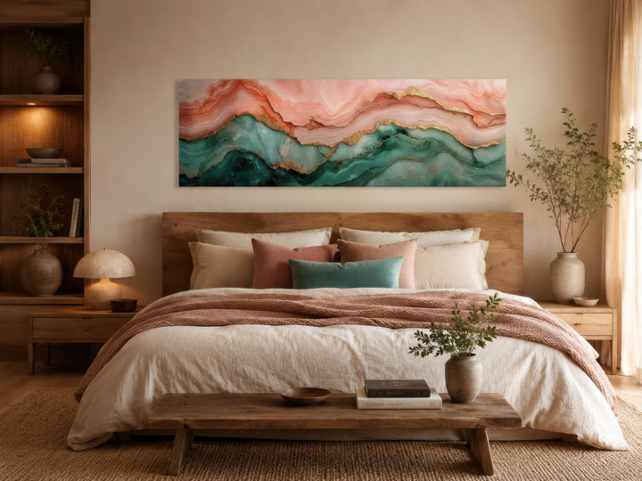 Sage green and blush pink abstract marble horizontal canvas wall art hanging above a bed.