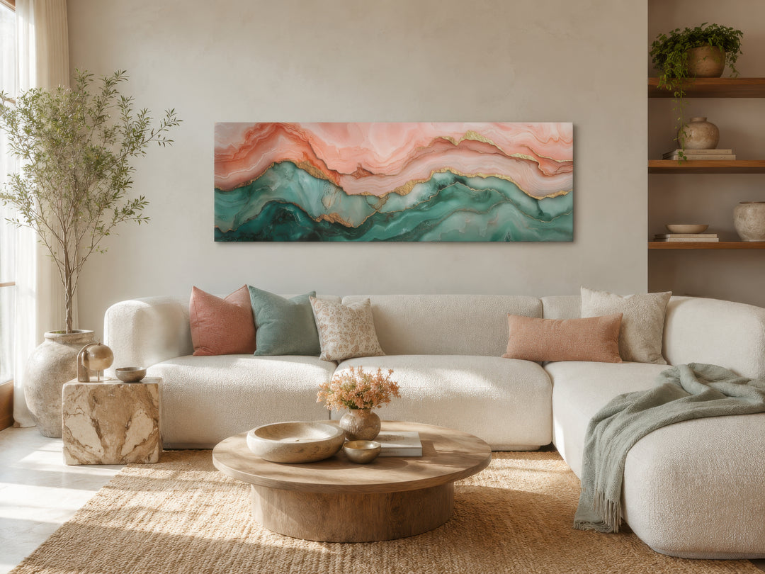 Sage green and blush pink abstract marble horizontal canvas wall art hanging above a white sofa.