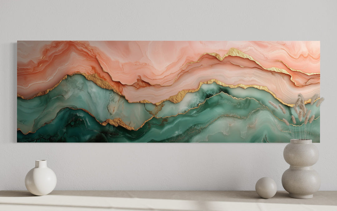 Sage green and blush pink abstract marble canvas wall art with gold accents above a neutral shelf.