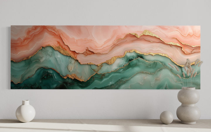 Sage green and blush pink abstract marble canvas wall art with gold accents above a neutral shelf.