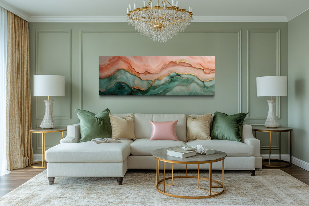 Horizontal abstract marble canvas art in sage green and blush pink above a white sectional sofa.