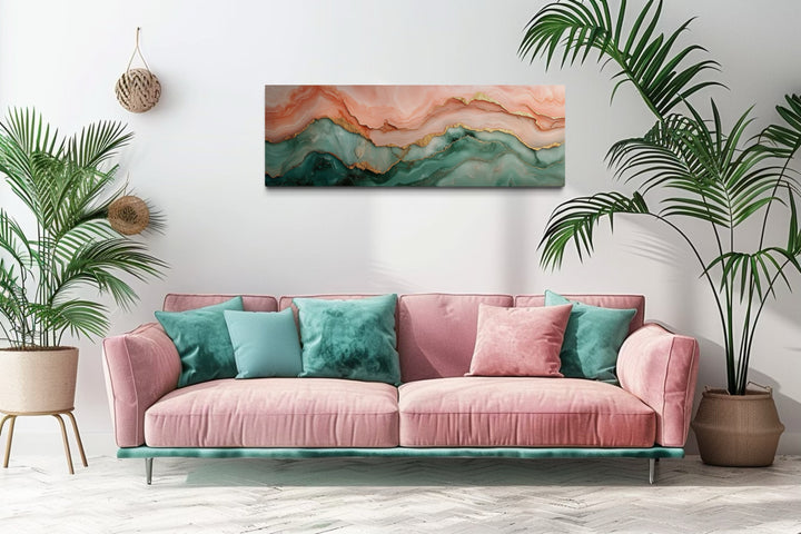 Sage green and blush pink abstract marble horizontal canvas wall art above a pink sofa.