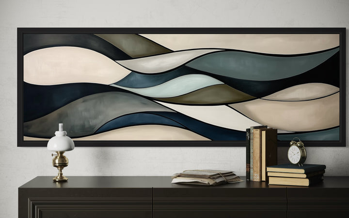 Sage green and brown modern abstract horizontal framed wall art displayed above a dark wood dresser.