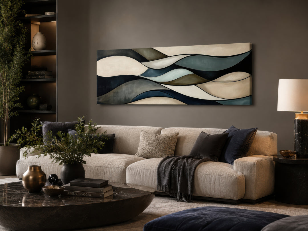 Sage green and brown modern abstract horizontal framed wall art hanging above a beige sofa.