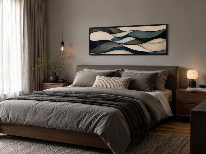 Sage green and brown modern abstract horizontal framed wall art hanging above a bed.