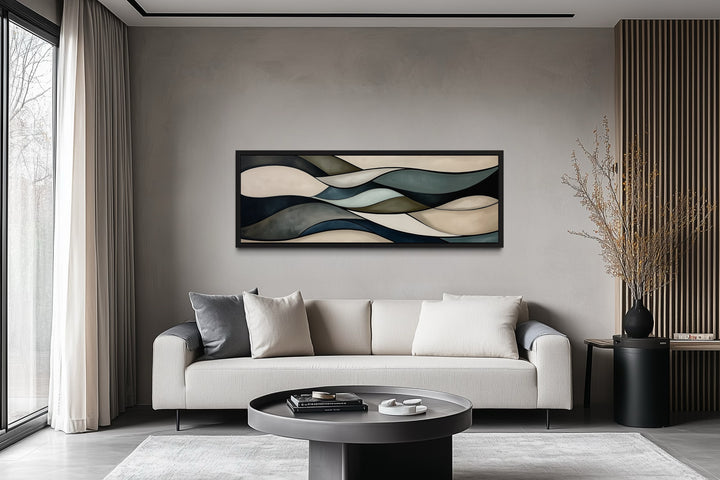 Sage green and brown modern abstract horizontal framed wall art hanging above a sofa in a room.