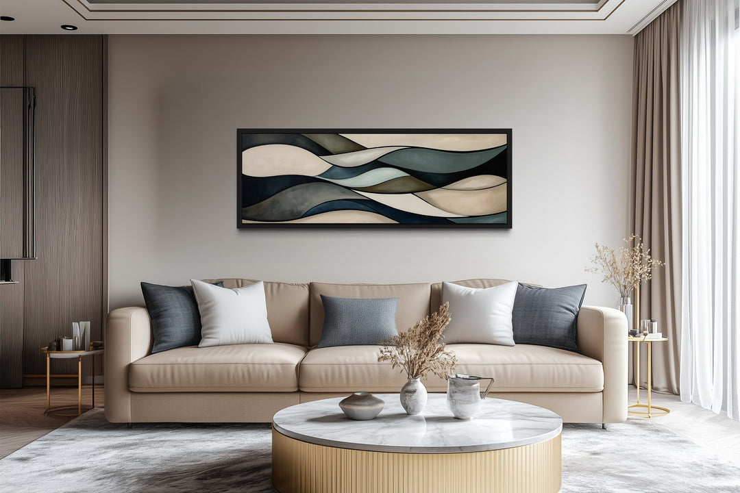 Sage green and brown modern abstract horizontal framed wall art hanging above a tan sofa.