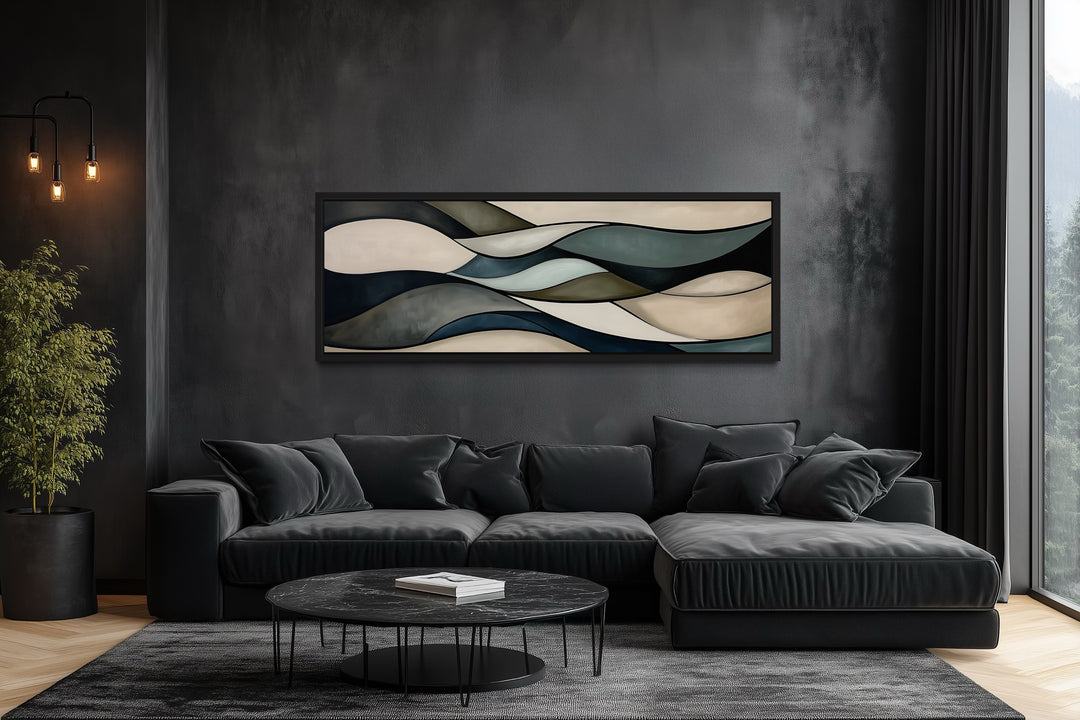 Sage green and brown modern abstract horizontal framed wall art hanging above a black sofa.