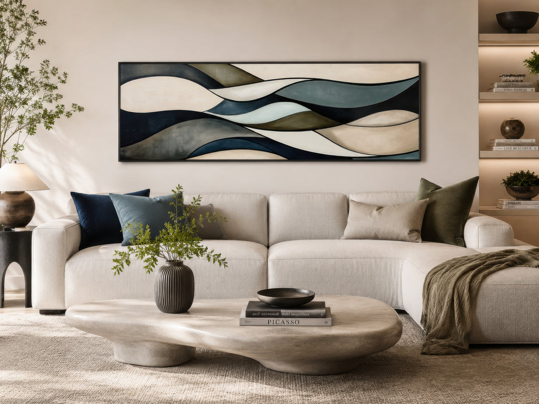 Sage green and brown modern abstract horizontal framed wall art hanging above a white sofa.