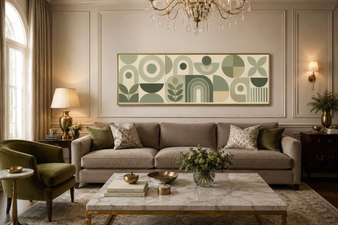 Long narrow sage green geometric canvas print with Bauhaus shapes above a sofa in a living room.