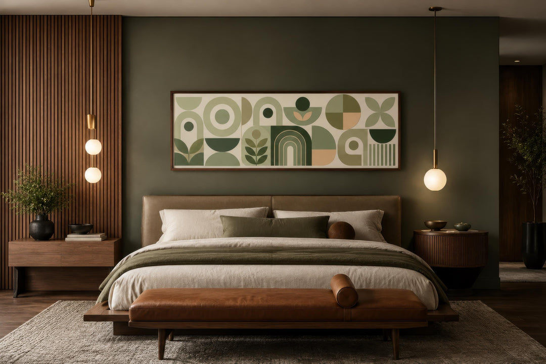 Sage green long narrow geometric canvas print with Bauhaus-style shapes above a bed in a bedroom.