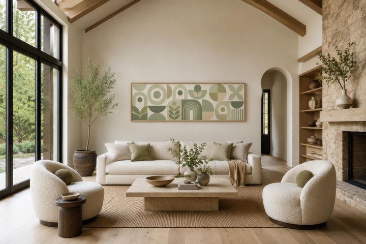 Sage green and cream long narrow geometric canvas wall art hanging above a sofa in a living room.