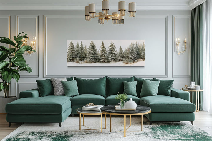 Sage green pine trees wall art on a long horizontal canvas above a green sectional sofa.