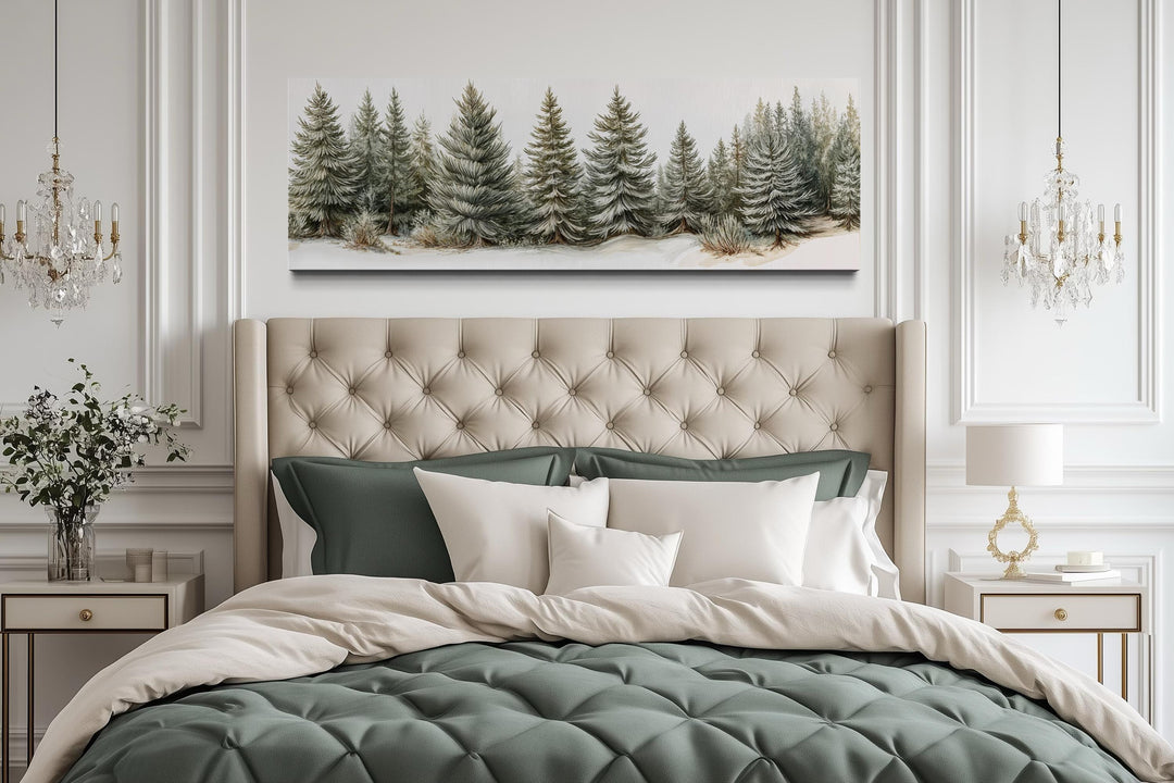 Sage green pine trees wall art on a long horizontal canvas above a tufted headboard.