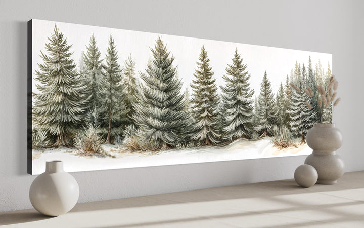 Sage green pine trees wall art on a long horizontal canvas in a neutral room setting.