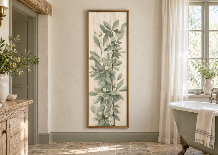 Tall slim vertical framed canvas wall art featuring vintage sage green leaves in a bathroom.