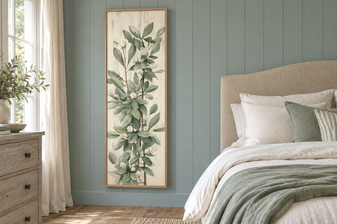 Tall slim vertical vintage sage green leaves framed canvas wall art in a bedroom setting.