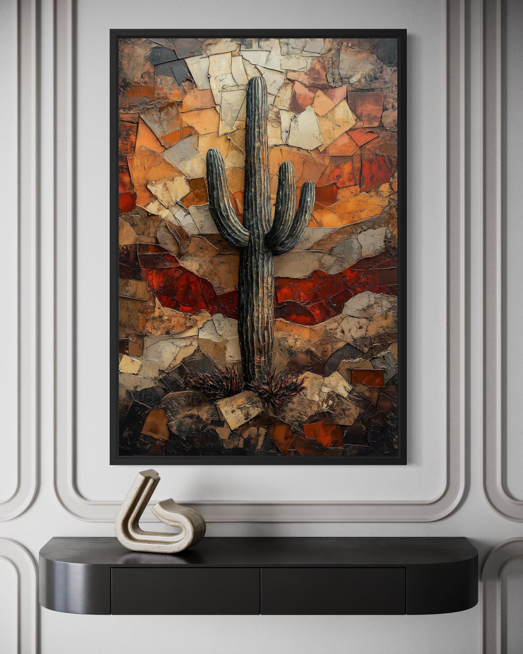 Saguaro cactus canvas print in rustic earthy tones hanging above a black console table.