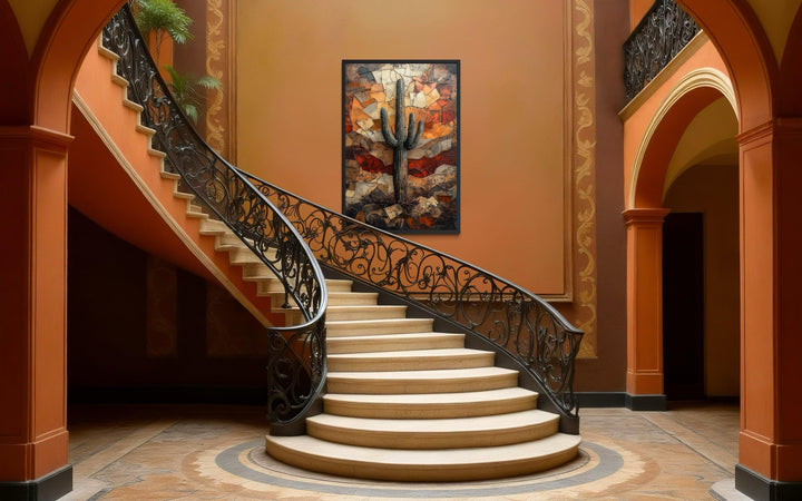 Vertical canvas print of a saguaro cactus in warm earthy tones hanging above a grand staircase.