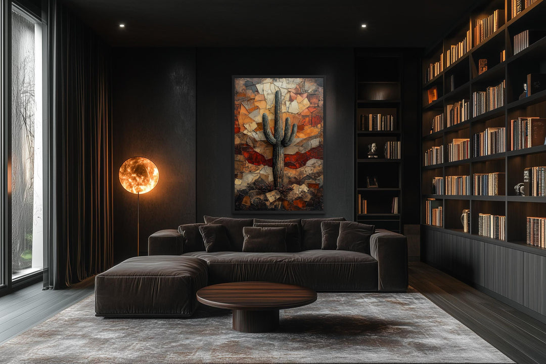 Saguaro Cactus Wall Art canvas print in a dark modern living room with a brown sofa and bookshelf.