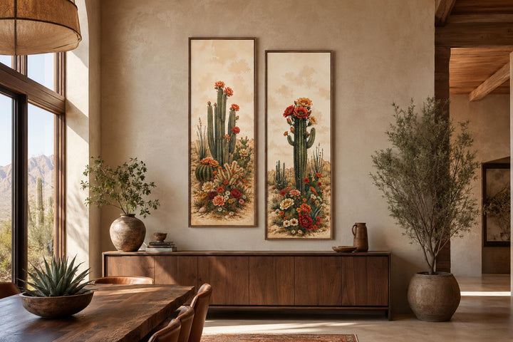 Set of 2 vertical botanical prints featuring saguaro cacti with red and orange blooms on a wall.