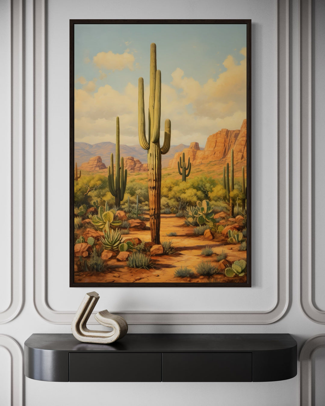 Framed canvas wall art of a Saguaro cactus in an Arizona desert landscape above a black console.