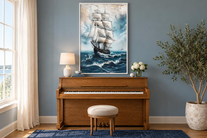 Sailing ship in blue ocean abstract coastal wall art in a white frame above a wooden piano.