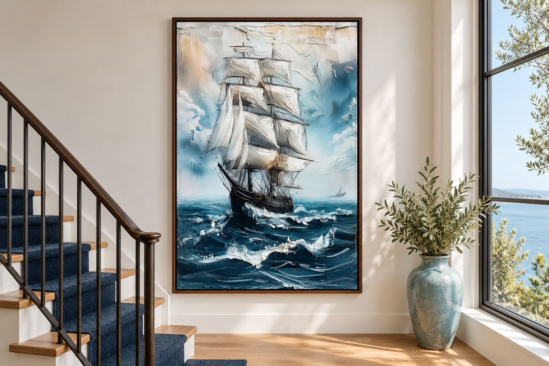 Abstract coastal wall art of a sailing ship on a blue ocean in a walnut frame on a white wall.
