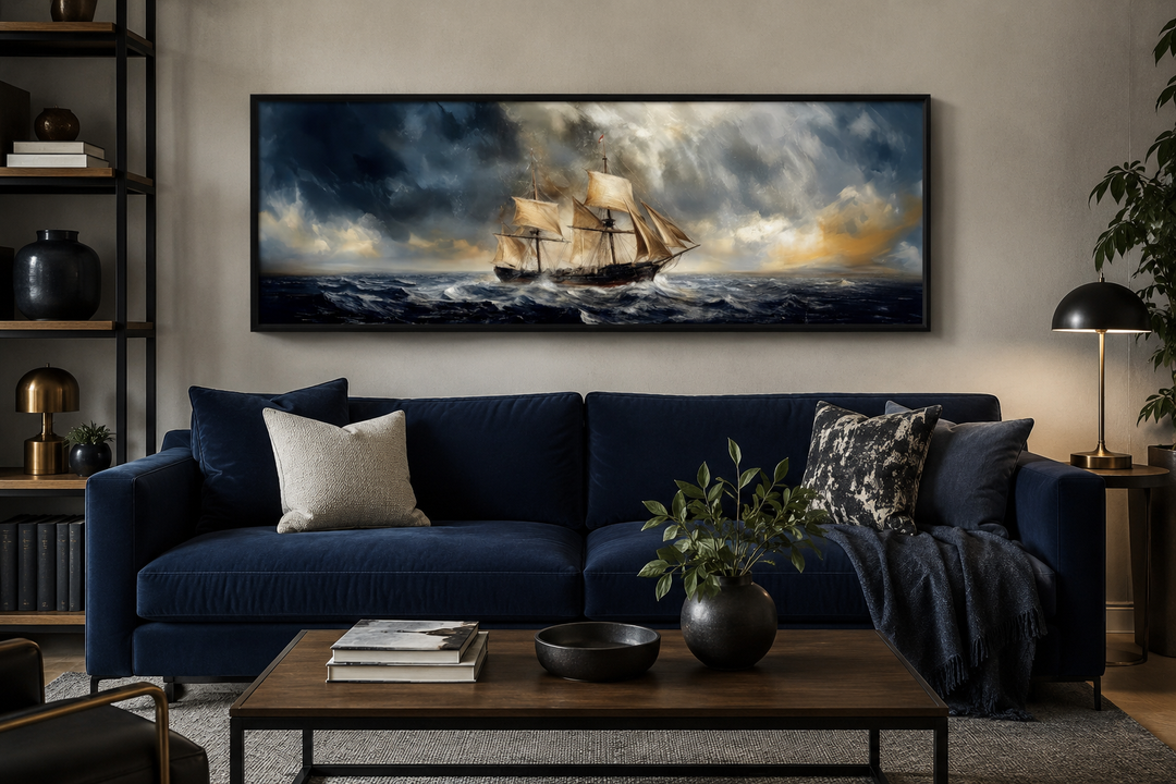 Sailing ship in a stormy sea on a long horizontal canvas above a blue sofa in a modern living room.