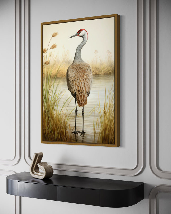 Sandhill Crane Vintage Framed Canvas Wall Art hanging above a black console table.