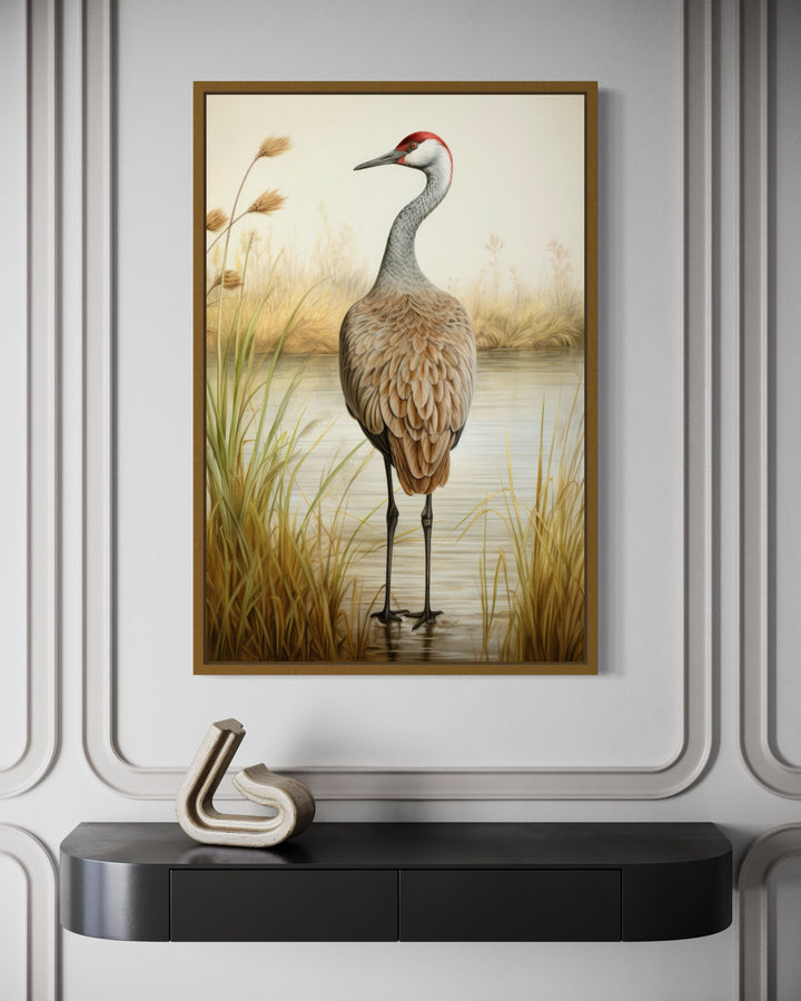 Sandhill Crane Vintage Framed Canvas Wall Art hanging above a black console table in a modern room.