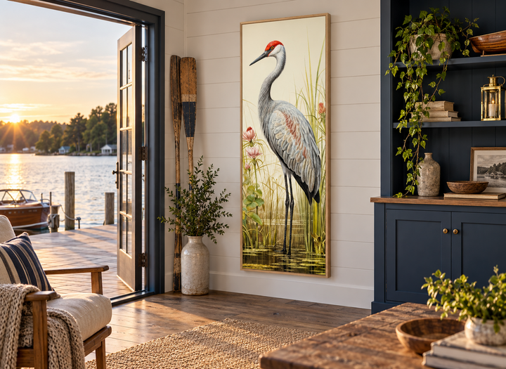 Tall narrow vertical canvas wall art of a sandhill crane in a wetland, hung in a lake house room.
