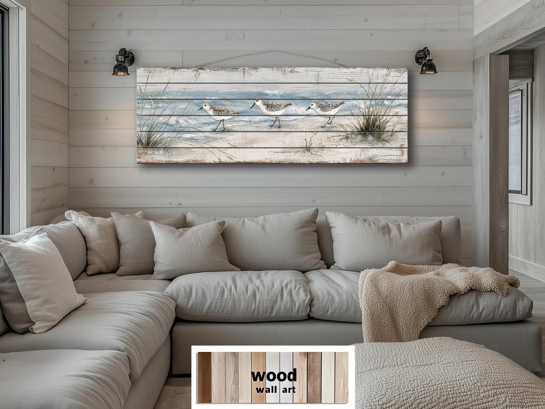 Long narrow wood wall art featuring three sandpipers on a beach for coastal home decor.