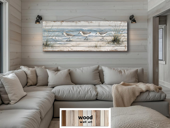 Long narrow wood wall art featuring three sandpipers on a beach for coastal home decor.