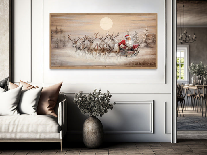 Rustic Santa Claus in sleigh with reindeer canvas wall art in a farmhouse living room.