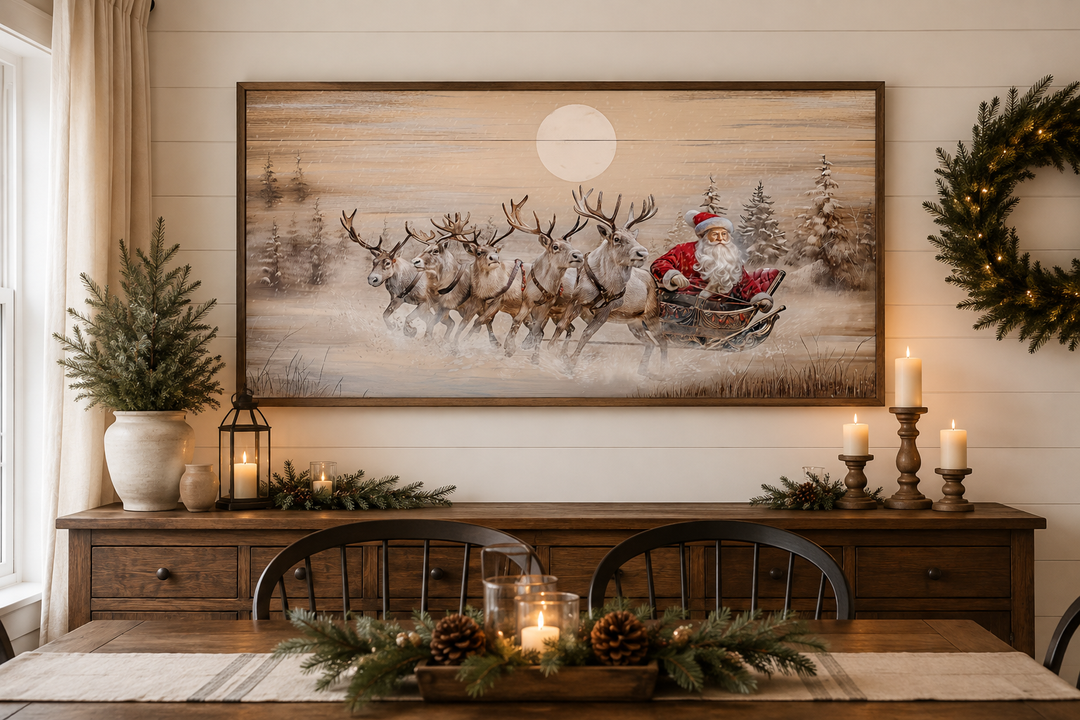 Rustic Santa Claus in sleigh with reindeer wall art above a wooden sideboard with holiday decor.
