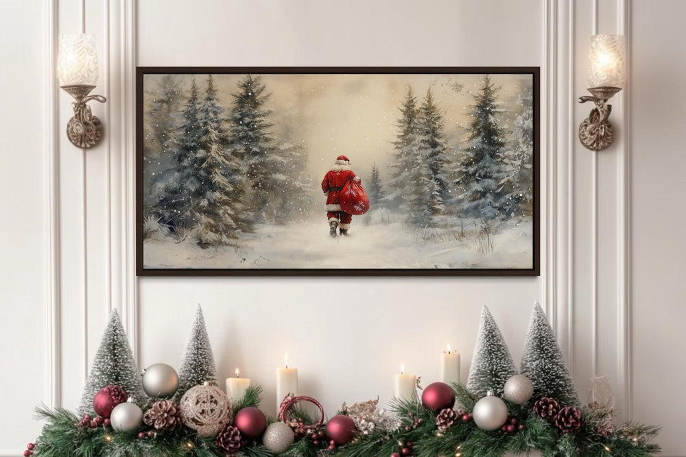 Santa walking through a snowy forest with a red sack, framed wall art above a decorated mantel.