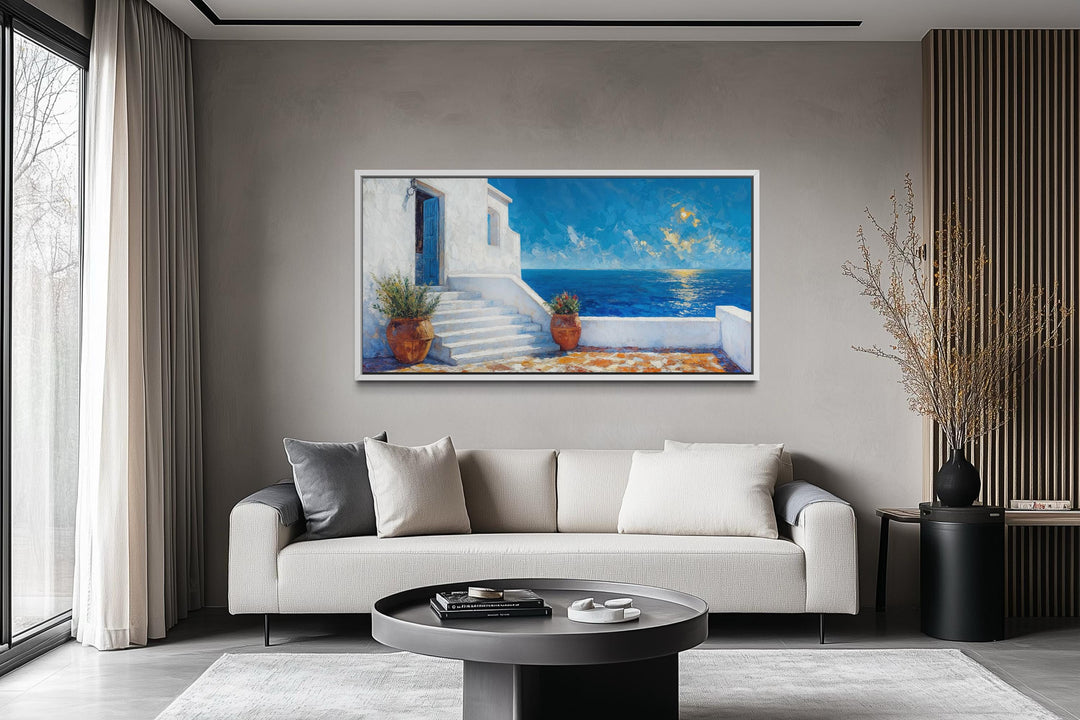 Horizontal canvas art of a Santorini villa overlooking the blue Aegean Sea in a modern living room.