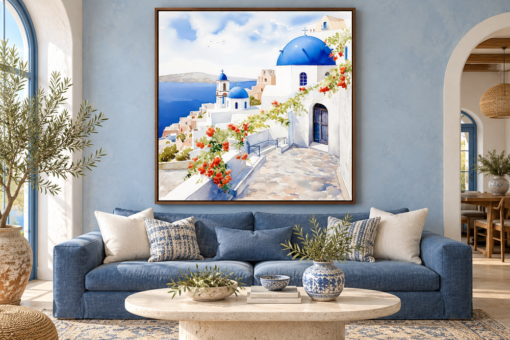 Santorini Greece watercolor framed canvas wall art hanging above a blue sofa in a living room.