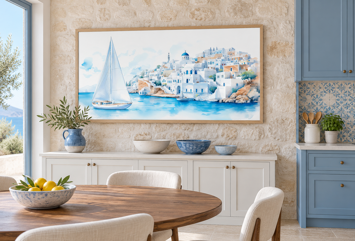Santorini Sea and Sailboat Framed Canvas Wall Art in an oak frame above a white sideboard.